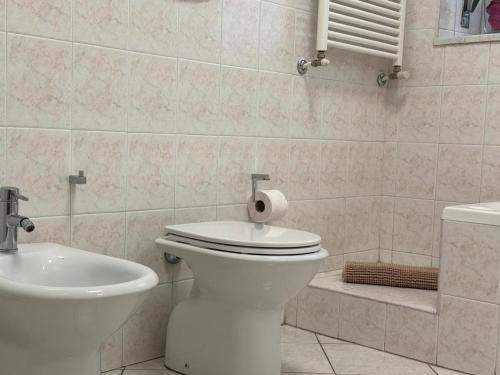 a white bathroom with a toilet and a sink at Dream house near Milano in Corsico