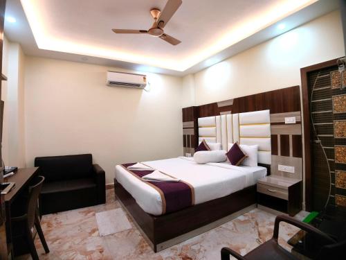 a hotel room with a bed and a desk at Elegant Beach Resort in Mandarmoni