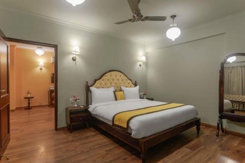 a bedroom with a large bed in a room at Hotel Chandra Raj Mahal in Bikaner