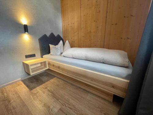 a bedroom with a bed in a wooden wall at Landhaus Elisabeth in Krün