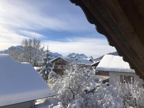 a view from a window of a snow covered house at Landhaus Elisabeth in Krün