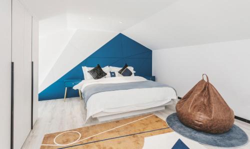 a bedroom with a bed with a blue wall at Dali Mermaid Seascape Resort Hotel in Dali