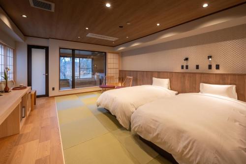 Ein Bett oder Betten in einem Zimmer der Unterkunft Senkyo
