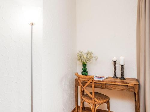 a room with a wooden desk with a chair at Apartment Suite Modern-17 by Interhome in Ascona