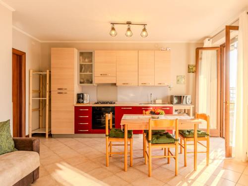 a kitchen and dining room with a table and chairs at Apartment Paníco by Interhome in Dorio