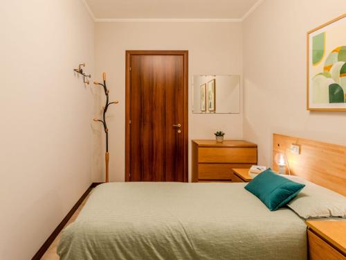 a bedroom with a bed and a wooden door at Apartment Paníco by Interhome in Dorio