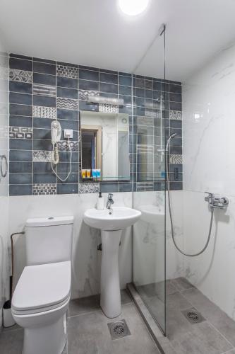 a bathroom with a toilet and a sink and a shower at Villa ARS in Belgrade