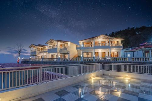 a house with a swimming pool at night at Paatli Fort Estate Resort in Kota Bāgh