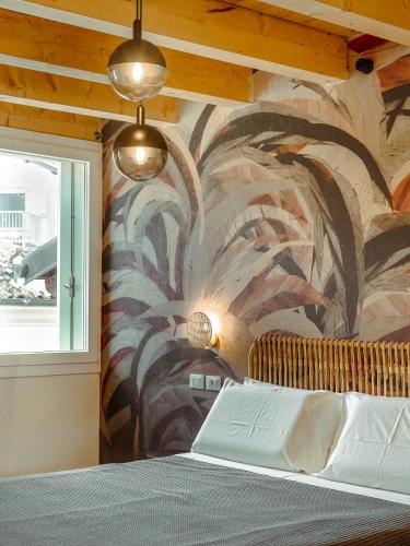 a bedroom with a wall with a mural at BRE Apartments - Lumen in Vicenza