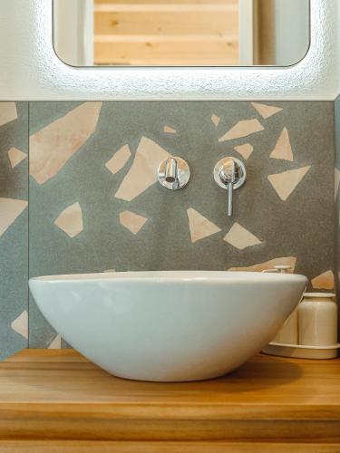 a white bowl on a counter in a bathroom at BRE Apartments - Lumen in Vicenza