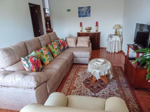 a living room with a couch and a coffee table at Holiday Home Das Serradas by Interhome in Vau