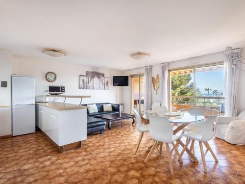 a kitchen and living room with a table and chairs at Apartment Les Regates-1 by Interhome in Hyères