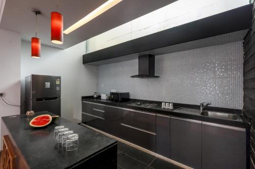 a kitchen with a black counter and a sink at St Jacinto Island Villa10 2Pools Bay View in Dabolim