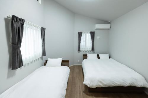 Postel nebo postele na pokoji v ubytování 堅粕汐風 K Ocean Breeze