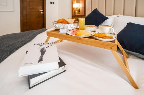 a breakfast tray on a bed with food on it at New Luxe 2 BR in Dubai