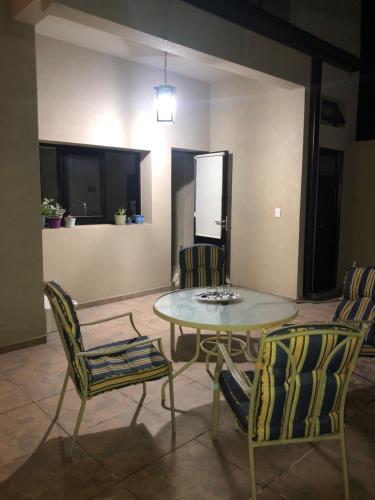 a dining room with a table and two chairs at La Estación C in Reconquista