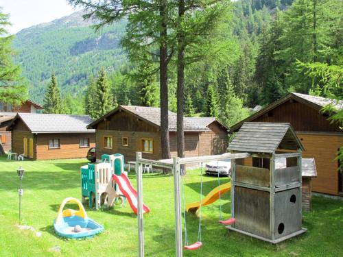 a yard with playground equipment and a house at Holiday Home Edelweiss-2 by Interhome in Saas-Balen