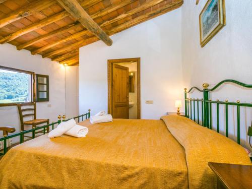 a bedroom with a large bed with towels on it at Apartment Colombaia by Interhome in Lucolena in Chianti