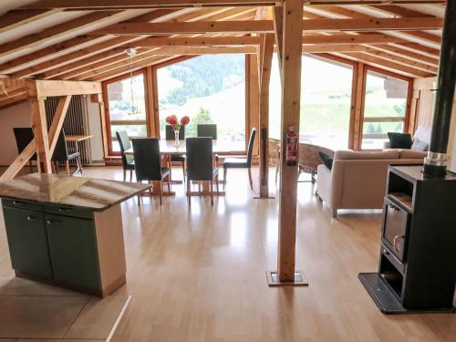a living room with a table and chairs at Apartment Cresta - SAV125 by Interhome in Savognin