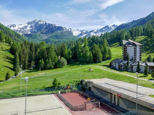 an aerial view of a building with mountains in the background at Apartment Rosablanche-108 by Interhome in Siviez