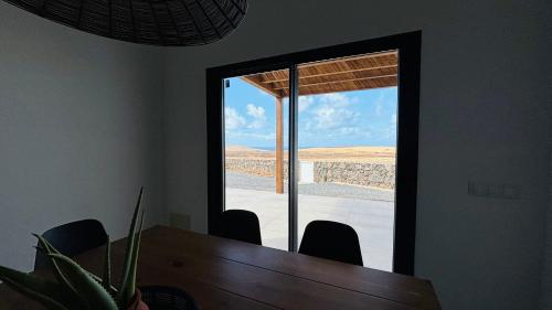 a mirror in a room with a table and chairs at Casa Magafral in Tindaya with heated pool in Tindaya