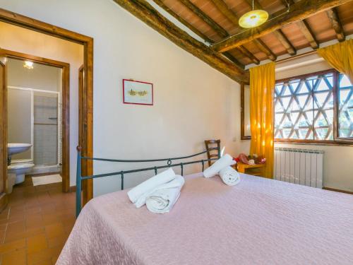 a bedroom with a bed with towels on it at Apartment La Vigna by Interhome in Lucolena in Chianti