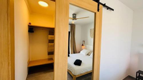 a small bedroom with a bed and a mirror at Casa Magafral in Tindaya with heated pool in Tindaya