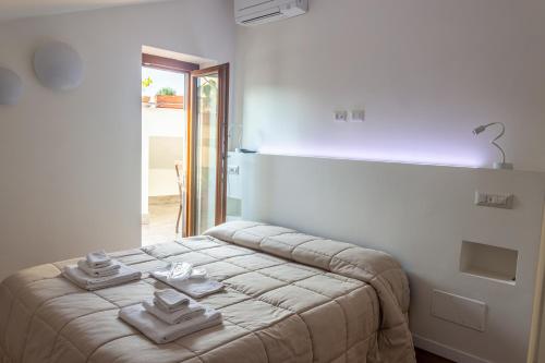 a bedroom with a bed with towels on it at gandino apartment in Rome