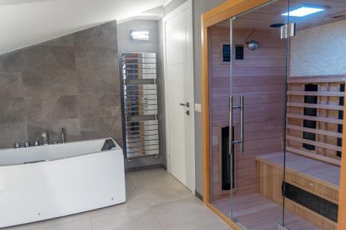 a bathroom with a glass shower and a white sink at gandino apartment in Rome