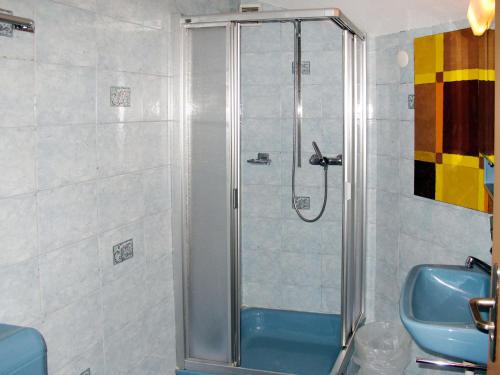 a shower in a bathroom with a blue sink at Apartment Haus Quelle-1 by Interhome in Saas-Grund