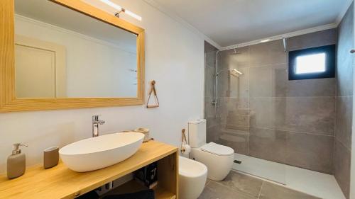 a bathroom with a sink and a toilet and a shower at Casa Magafral in Tindaya with heated pool in Tindaya