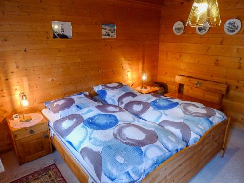 a bedroom with a bed in a wooden room at Chalet Chalet Walliserträumli - BET410 by Interhome in Grengiols