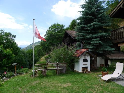 a flag in the yard of a house at Chalet Chalet Walliserträumli - BET410 by Interhome in Grengiols