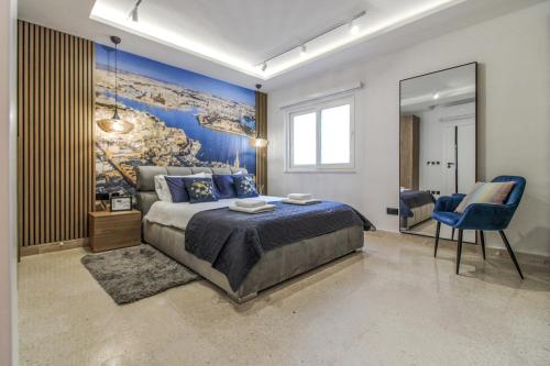 a bedroom with a large bed and a blue wall at Designer - 60 Seconds to the Beach I Free Parking! in St Julian's