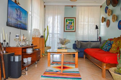 a living room with a couch and a table at The Bukoto Loft in Kampala