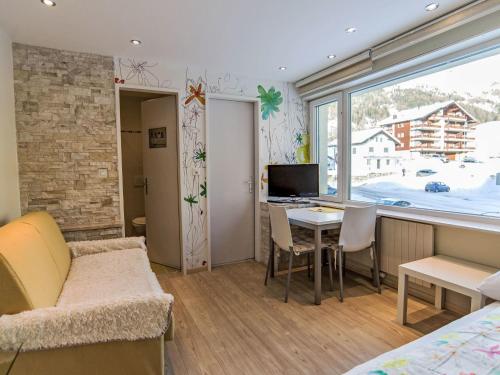 a bedroom with a bed and a desk with a computer at Studio Cristal 36 by Interhome in Leukerbad