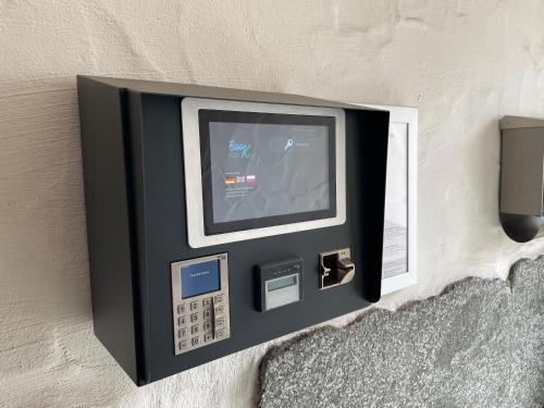 a television attached to a wall with a wall at Hotel Elsen in Grevenbroich