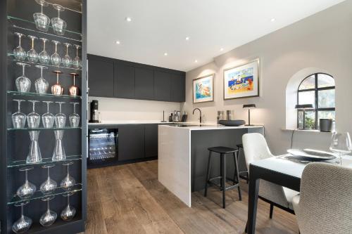 a kitchen with black cabinets and a table with chairs at Greta s Hüs in Archsum