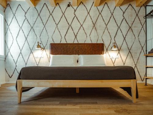 a bedroom with a bed with a wooden headboard at BRE Apartments - Pax in Vicenza