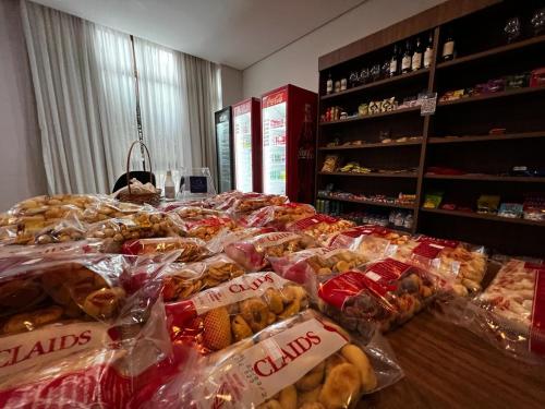 a large pile of food on a table in a store at Flat Condomínio Vista Azul - Pedra Azul in Pedra Azul