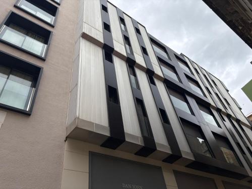 a tall building with black and white stripes on it at REUSIA Apartaments in Reus