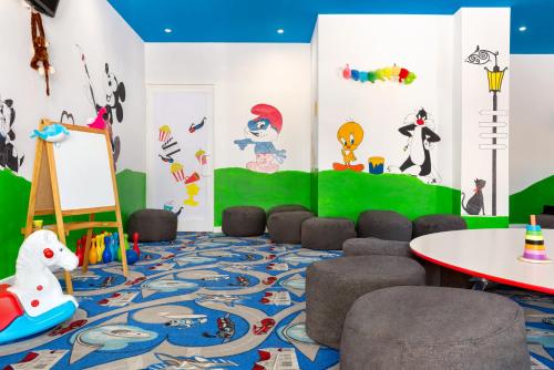 a childrens room with a table and chairs at Unique Residence Hotel Golf and Spa in Soke
