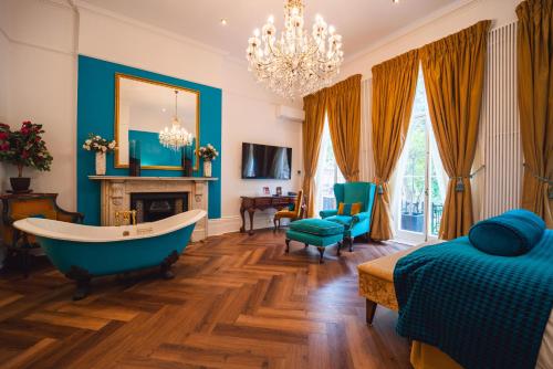 a bathroom with a tub and a bed and a fireplace at Twenty Nevern Square Hotel in London