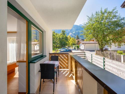 a balcony with a table and chairs and a view at Apartment Rosa-6 by Interhome in Mayrhofen
