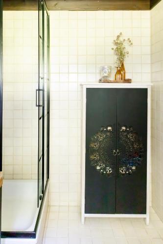 a bathroom with a shower and a black door at Geographer`s Cottage II in Siegsdorf