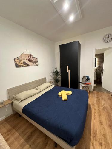 a bedroom with a blue bed with a cross on it at Palmina's Apartments in Brindisi