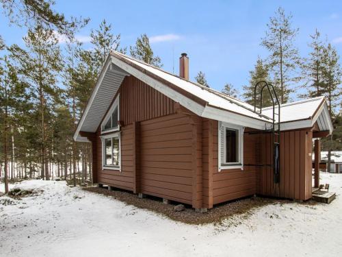 a small cabin in the snow in the woods at Holiday Home Puolukka 2 by Interhome in Isnäs