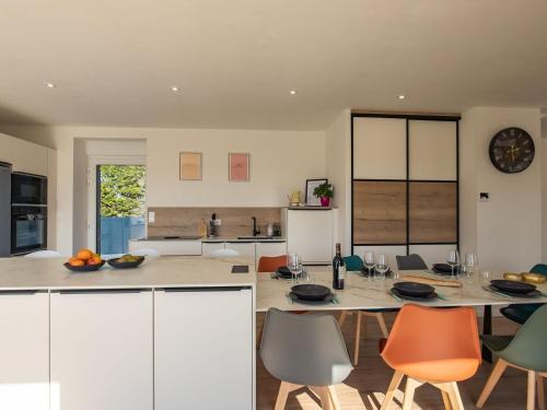 a kitchen and dining room with a table and chairs at Holiday Home La Maison de Parrain by Interhome in Kerlouan