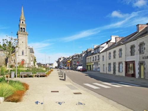 a street in a town with a clock tower at Holiday Home La Maison de Parrain by Interhome in Kerlouan