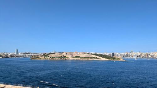 an island in the middle of a large body of water at Valletta Authentic Apartment in Valletta